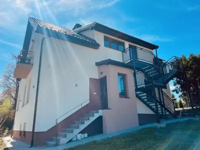 a house with stairs on the side of it at Zakątek Solny in Bochnia