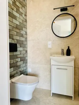 a bathroom with a toilet and a sink and a mirror at Zakątek Solny in Bochnia