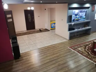 a room with a living room with a tv and a floor at Apartament u Wioli in Okleśna