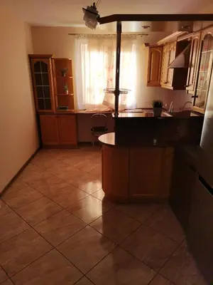 a kitchen with a large tiled floor at Apartament u Wioli in Okleśna