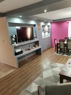 a living room with a flat screen tv on a wall at Apartament u Wioli in Okleśna