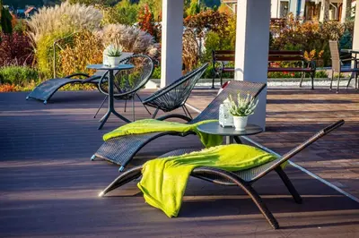 a group of chairs and tables with a yellow blanket on them at Hotel Łokietek in Czajowice