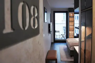 a hallway with a room with a bed and a balcony at BOUTIQUE 108 - old city, luxury apt. with a garage in Kraków