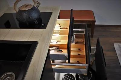 a kitchen with a wooden counter with wooden drawers at BOUTIQUE 108 - old city, luxury apt. with a garage in Kraków