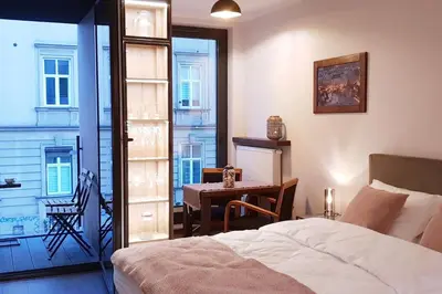 a bedroom with a bed and a table and a window at BOUTIQUE 108 - old city, luxury apt. with a garage in Kraków