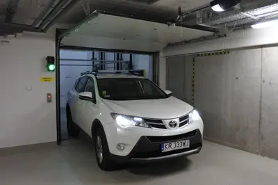 a white car is parked in a garage at BOUTIQUE 108 - old city, luxury apt. with a garage in Kraków