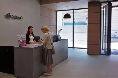 two women standing at a counter in an office at BOUTIQUE 108 - old city, luxury apt. with a garage in Kraków