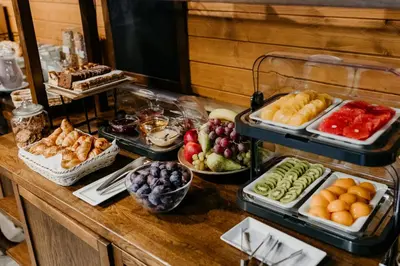 a buffet with different types of food on a table at Hotel Yarden by Artery Hotels in Kraków