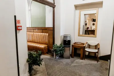 a room with a couch and a table and a mirror at Hotel Yarden by Artery Hotels in Kraków
