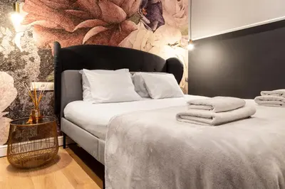 a bedroom with a bed with towels on it at HOUSEHOST Apartment: Łazarza II street in Kraków