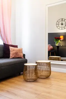 a living room with a couch and two tables at HOUSEHOST Apartment: Łazarza II street in Kraków
