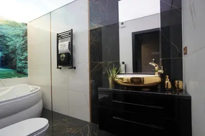 a bathroom with a sink and a toilet at Apartament Lema Versace in Kraków