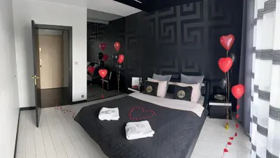 a bedroom with a bed with red balloons and red hearts at Apartament Lema Versace in Kraków