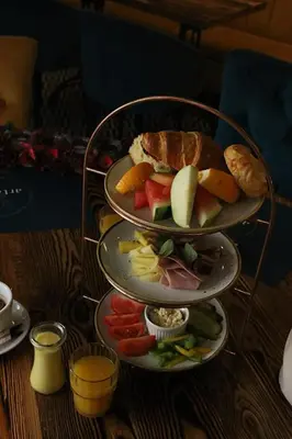 three plates of food on top of a table at Rainbow Apartments 3 in Kraków