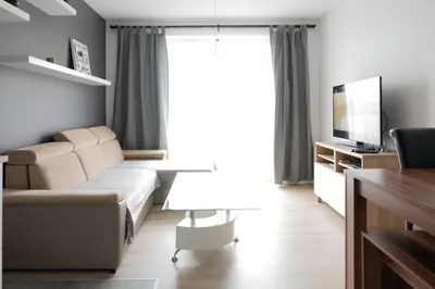 a living room with a couch and a television at Republiki Korczakowskiej Ferienwohnung in Kraków