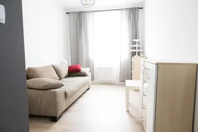 a living room with a couch and a table at Republiki Korczakowskiej Ferienwohnung in Kraków