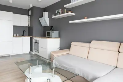 a living room with a couch and a table at Republiki Korczakowskiej Ferienwohnung in Kraków