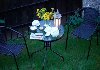 a table with a tea pot and flowers on it at Ojców Bazar Lwowski in Ojców