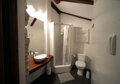 a white bathroom with a sink and a toilet at Ojców Bazar Lwowski in Ojców