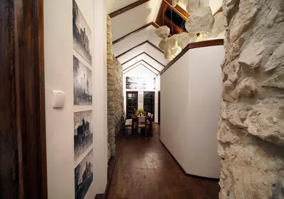 a hallway of a house with a stone wall at Ojców Bazar Lwowski in Ojców