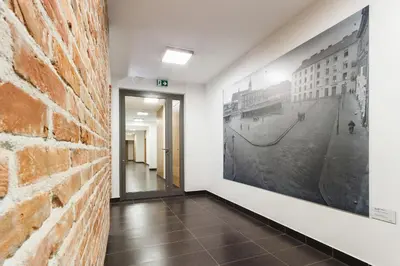 a hallway with a brick wall and a picture on the wall at Apartament 3d GO by Noclegi Renters in Kraków