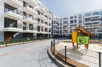 an empty street in front of an apartment building at Apartament 3d GO by Noclegi Renters in Kraków