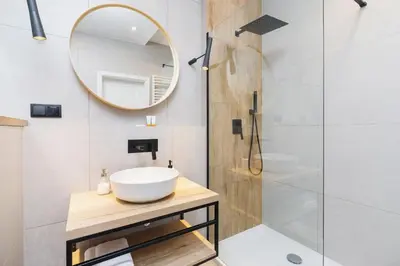 a bathroom with a sink and a mirror at Apartament 3d GO by Noclegi Renters in Kraków