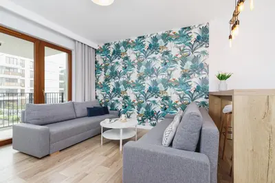 a living room with a couch and a table at Apartament 3d GO by Noclegi Renters in Kraków