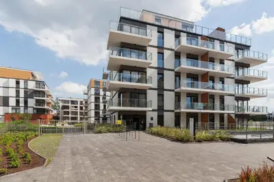 a large apartment building with a parking lot at Apartments Cracow Rakowicka by Noclegi Renters in Kraków