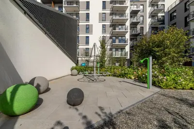 a patio in a building with a green sculpture at Apartments Cracow Rakowicka by Noclegi Renters in Kraków
