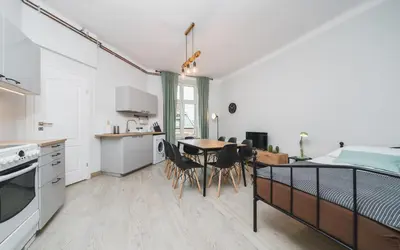 a white bedroom with a bed and a window at Beautiful Apartment on Main Square / Old Town / City Center in Kraków