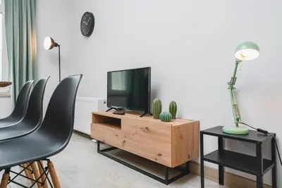 a kitchen and living room with a table and chairs at Beautiful Apartment on Main Square / Old Town / City Center in Kraków