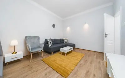 a living room with a tv on a wooden entertainment center at Beautiful Apartment on Main Square / Old Town / City Center in Kraków