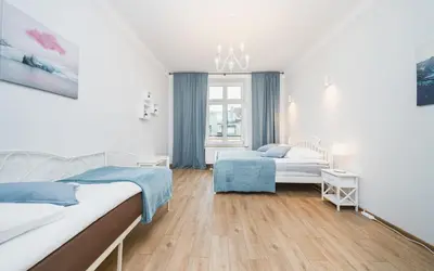 a bedroom with a bed with a painting on the wall at Beautiful Apartment on Main Square / Old Town / City Center in Kraków