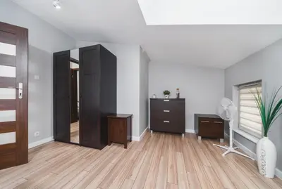 an empty room with a closet and a dresser at Deluxe Apartments Kraków Brzozowa by Noclegi Renters in Kraków