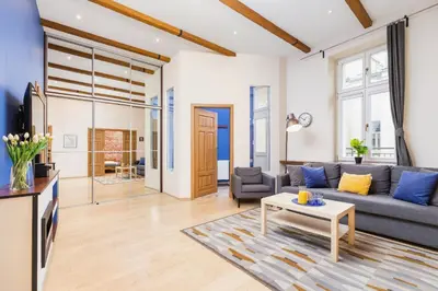 a living room with a couch and a table at Deluxe Apartments Kraków Brzozowa by Noclegi Renters in Kraków