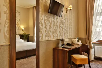 a hotel room with a bed and a couch at Amber Boutique Hotels - Amber Design in Kraków