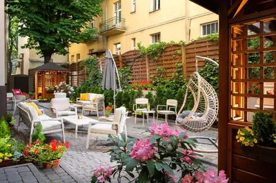 a patio with a lot of chairs and tables at Amber Boutique Hotels - Amber Design in Kraków