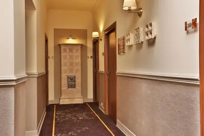 a white picture frame on a wall at Amber Boutique Hotels - Amber Design in Kraków