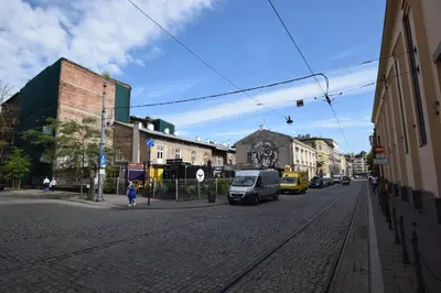 a city street with cars parked on the street at Jewish Quarter Small Apartment in Kraków