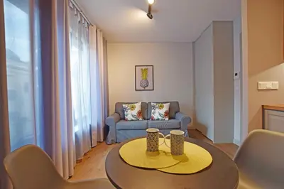 a living room with a table and a couch at Jewish Quarter Small Apartment in Kraków