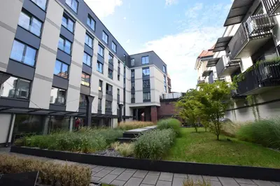 a courtyard of an apartment building with a garden at Jewish Quarter Small Apartment in Kraków