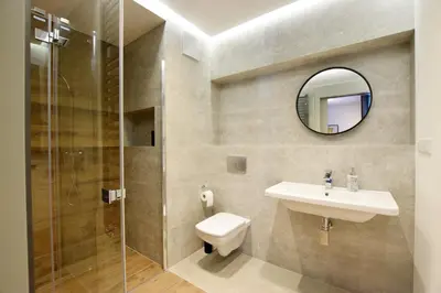 a bathroom with a toilet and a sink and a mirror at Jewish Quarter Small Apartment in Kraków