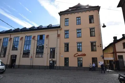 a large building with a clock tower on a street at Jewish Quarter Small Apartment in Kraków