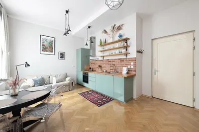 a living room with a blue couch and a table at Premium Apartment Old Town Topolowa in Kraków