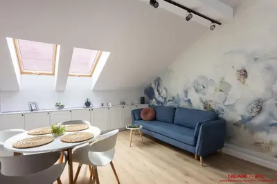 a kitchen with white cabinets and a table and chairs at Premium Apartment Old Town Topolowa in Kraków