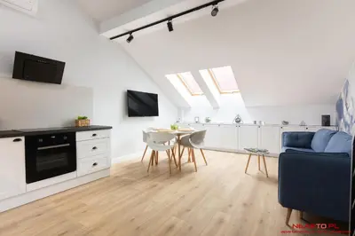 a kitchen with white cabinets and a black oven at Premium Apartment Old Town Topolowa in Kraków