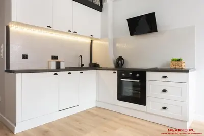 a kitchen with a table and chairs and a tv at Premium Apartment Old Town Topolowa in Kraków