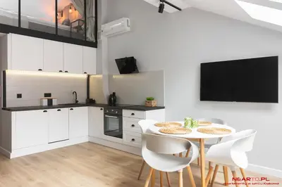 a kitchen with white cabinets and a black oven at Premium Apartment Old Town Topolowa in Kraków