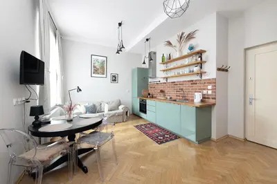 a kitchen and dining room with a table and chairs at Premium Apartment Old Town Topolowa in Kraków